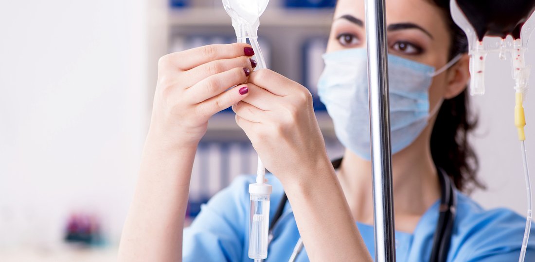 Young female doctor in infusion concept IV Therapy