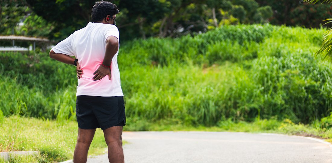 runner black man wear watch feel pain on his spine low back Low Back Pain
