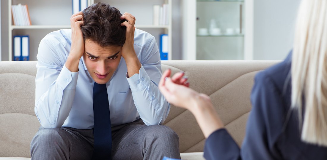 Young man visiting psychiatrist doctor for consultation Men's Counselling