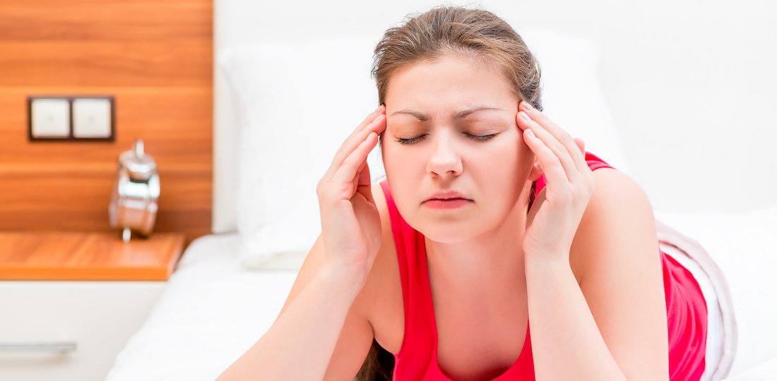 young brunette woman suffering from migraine Headaches and Migraines