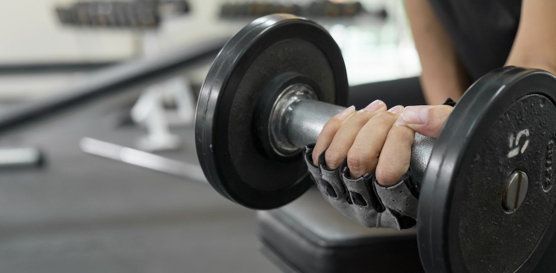 athletic young woman doing a fitness workout with dumbbell Sports Injuries