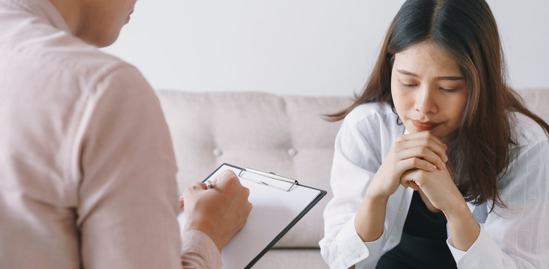 women Asian patients with man psychologist examination consulting and In psychotherapy by the physician in the clinic. psychiatrist concept Counselling for Students